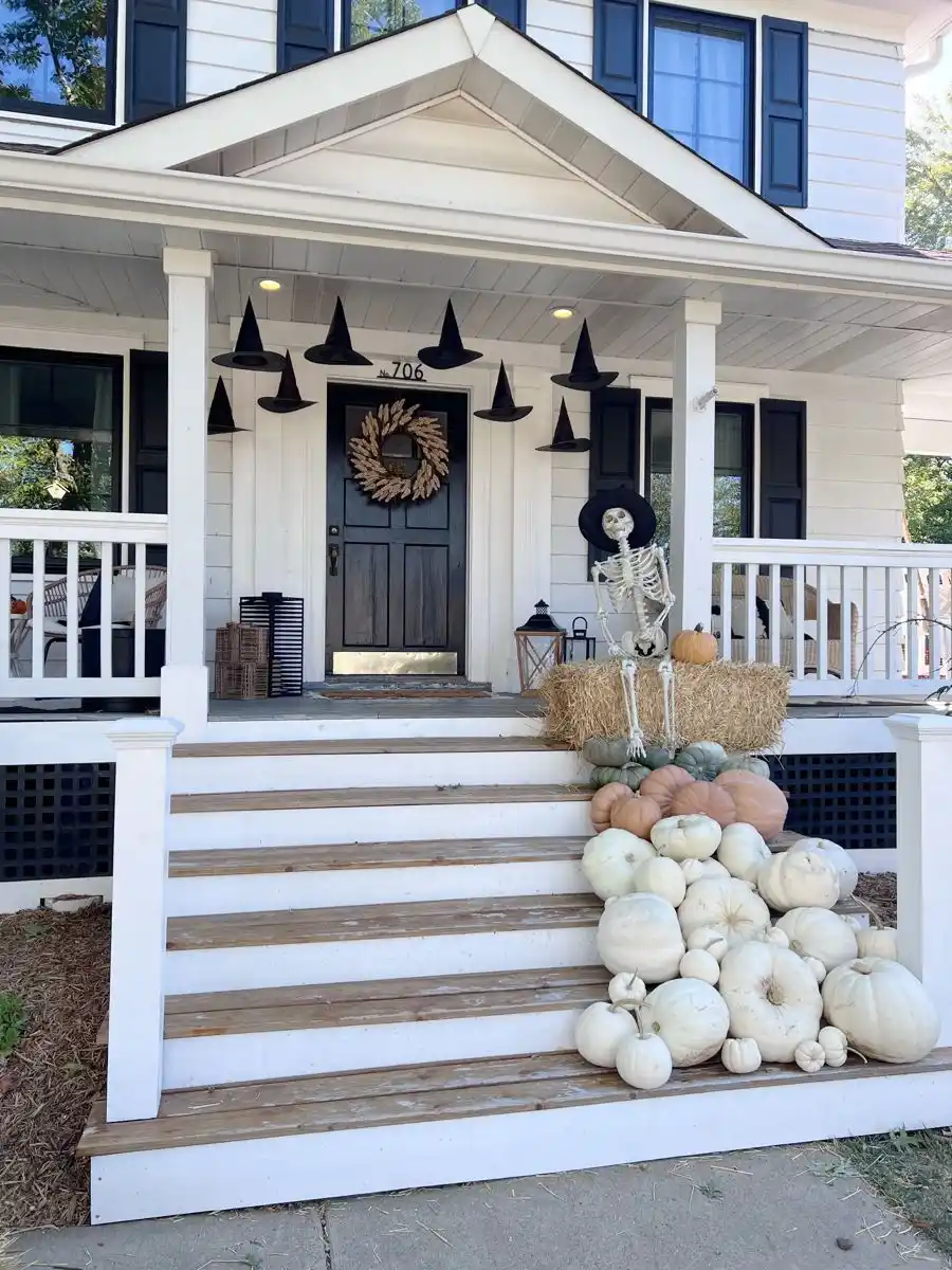 Witch-Themed Porch with Broomsticks and Hats
